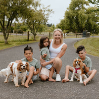 Dr Julie Bhosale and family holding dogs and smiling